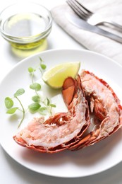 Photo of Delicious boiled lobster served on white table, closeup