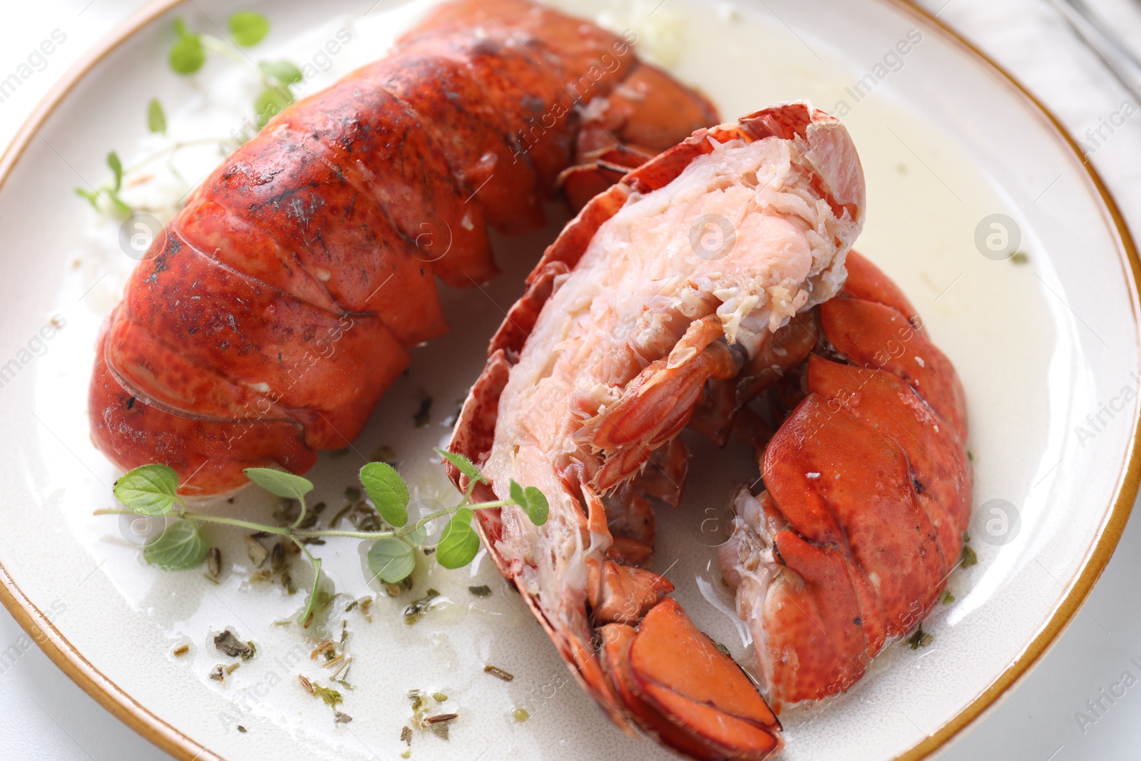 Photo of Delicious tails of boiled lobsters served on white table, closeup