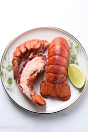 Photo of Delicious tails of boiled lobsters served on white table, top view