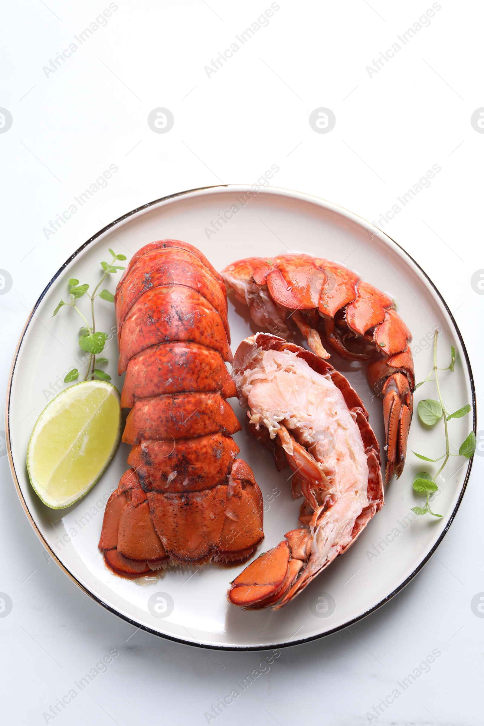 Photo of Delicious tails of boiled lobsters served on white table, top view