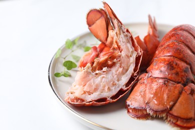 Photo of Delicious tails of boiled lobsters served on white table, closeup. Space for text