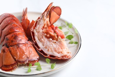 Photo of Delicious tails of boiled lobsters served on white table, closeup. Space for text