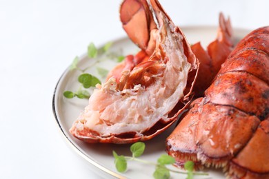 Photo of Delicious tails of boiled lobsters served on white table, closeup