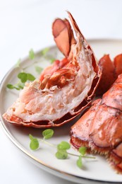 Photo of Delicious tails of boiled lobsters served on white table, closeup