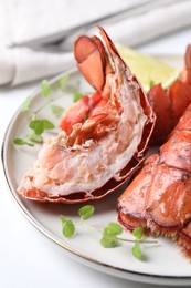 Photo of Delicious tails of boiled lobsters served on white table, closeup