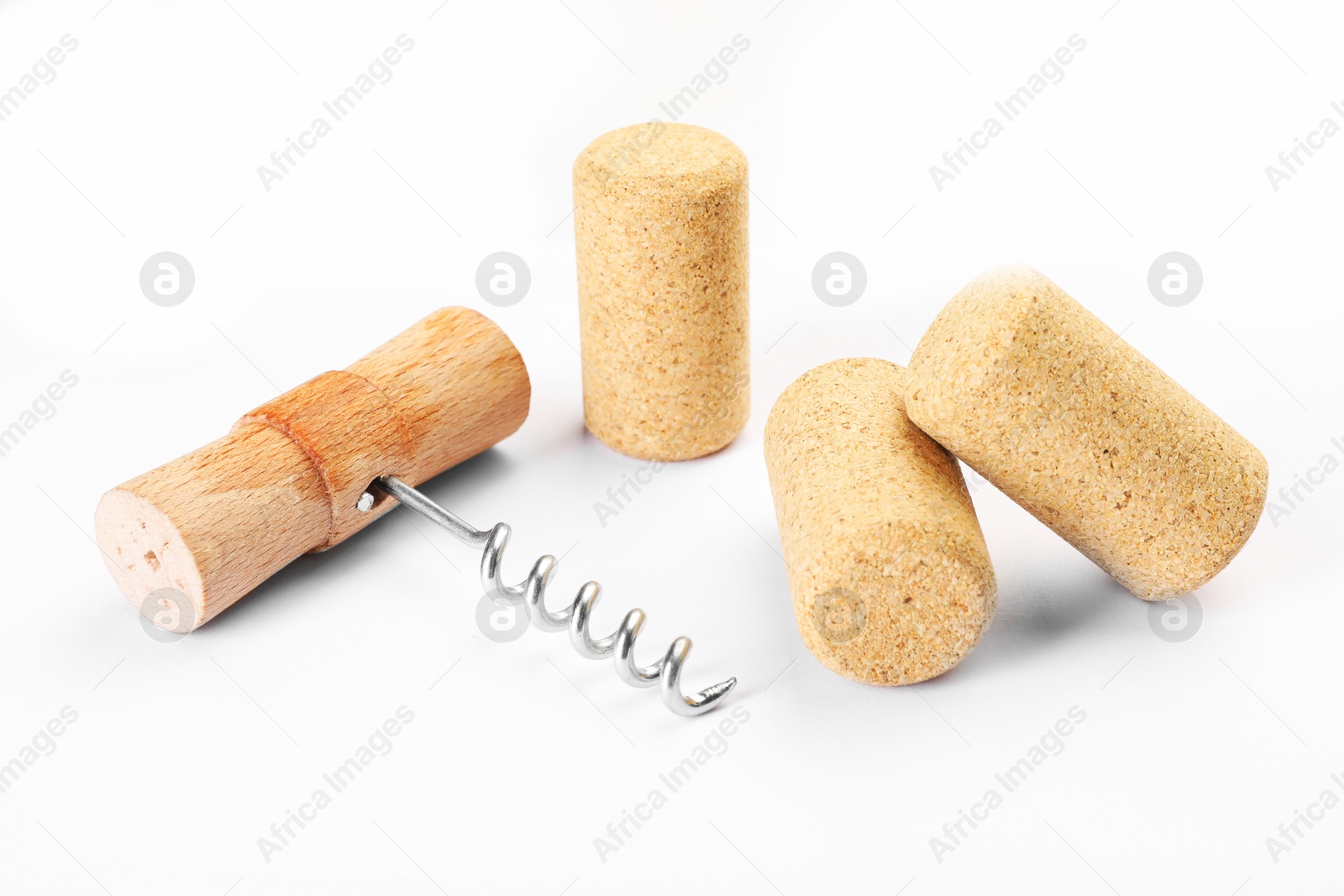 Photo of Corkscrew with wooden handle and corks on white background