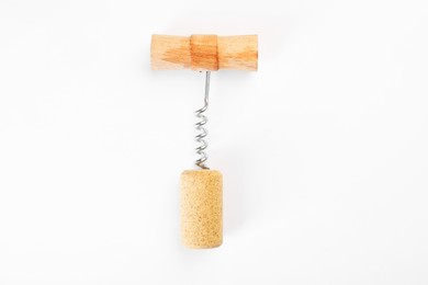 Photo of Corkscrew and cork on white background, top view