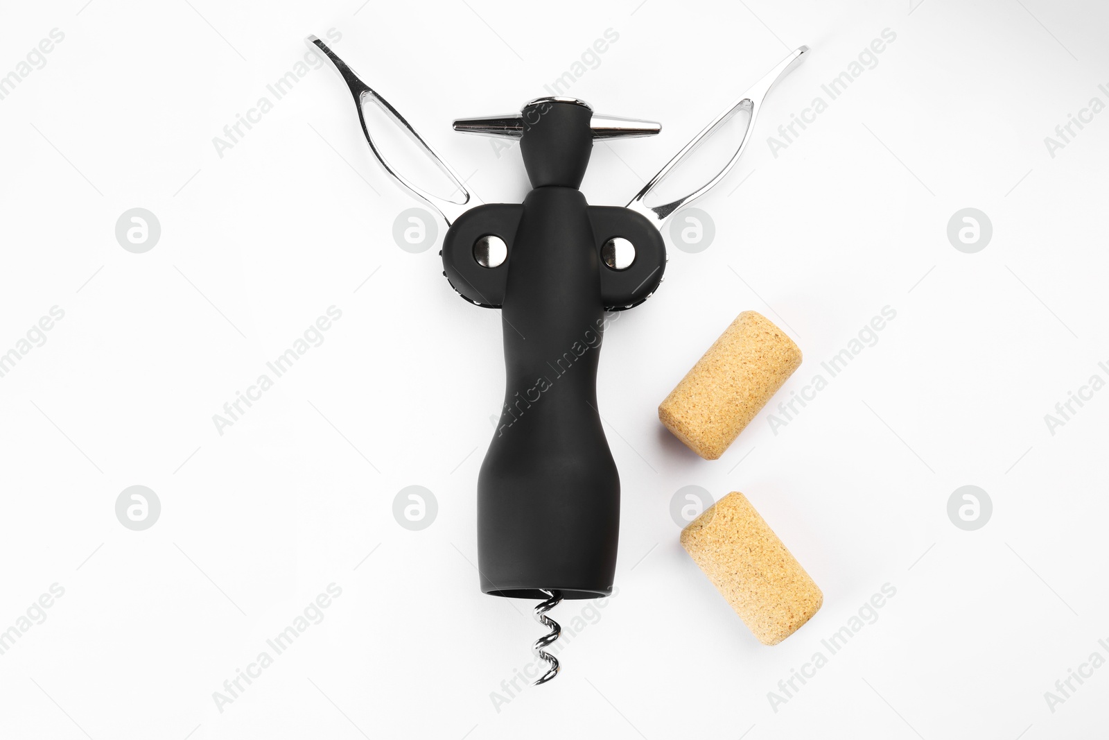 Photo of Wing corkscrew and corks on white background, top view