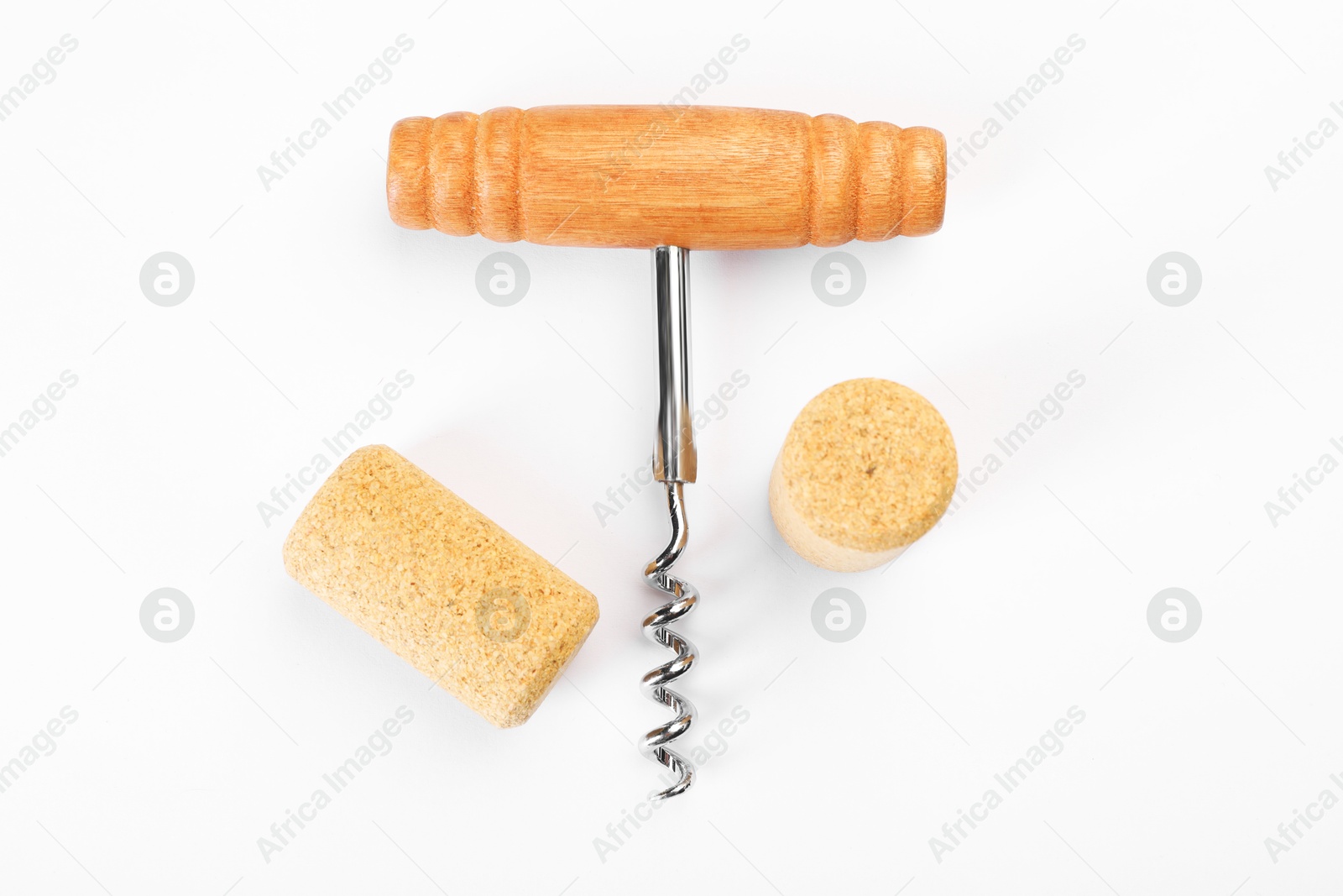 Photo of Corkscrew and corks on white background, top view