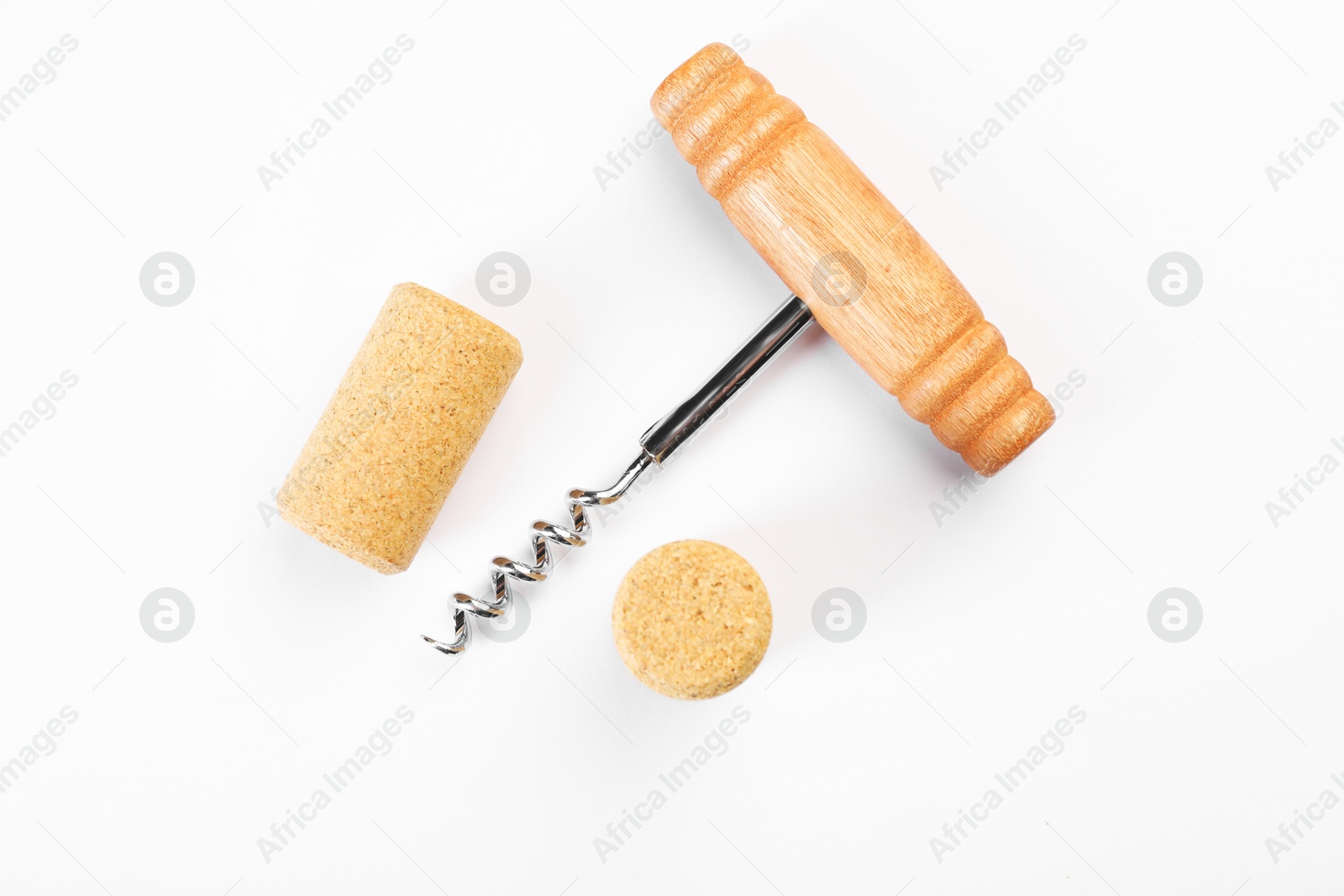 Photo of Corkscrew and corks on white background, top view