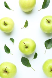 Photo of Green apples and leaves on white background, flat lay