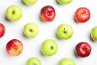 Red and green apples on white background, flat lay