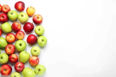 Photo of Red and green apples on white background, flat lay. Space for text