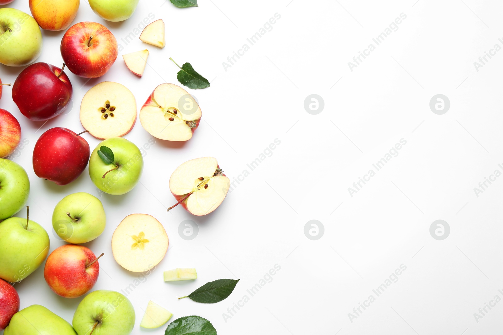 Photo of Flat lay composition with whole and cut apples on white background. Space for text