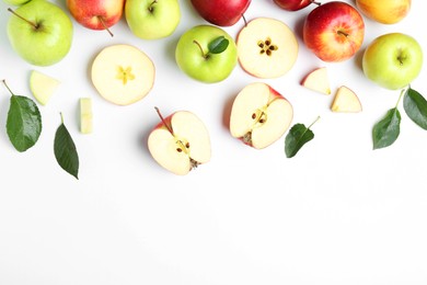 Photo of Flat lay composition with whole and cut apples on white background. Space for text