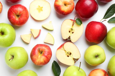 Photo of Flat lay composition with whole and cut apples on white background