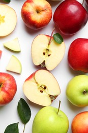 Flat lay composition with whole and cut apples on white background