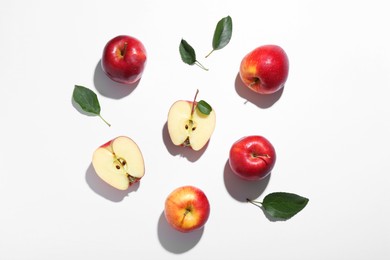 Flat lay composition with whole and cut apples on white background