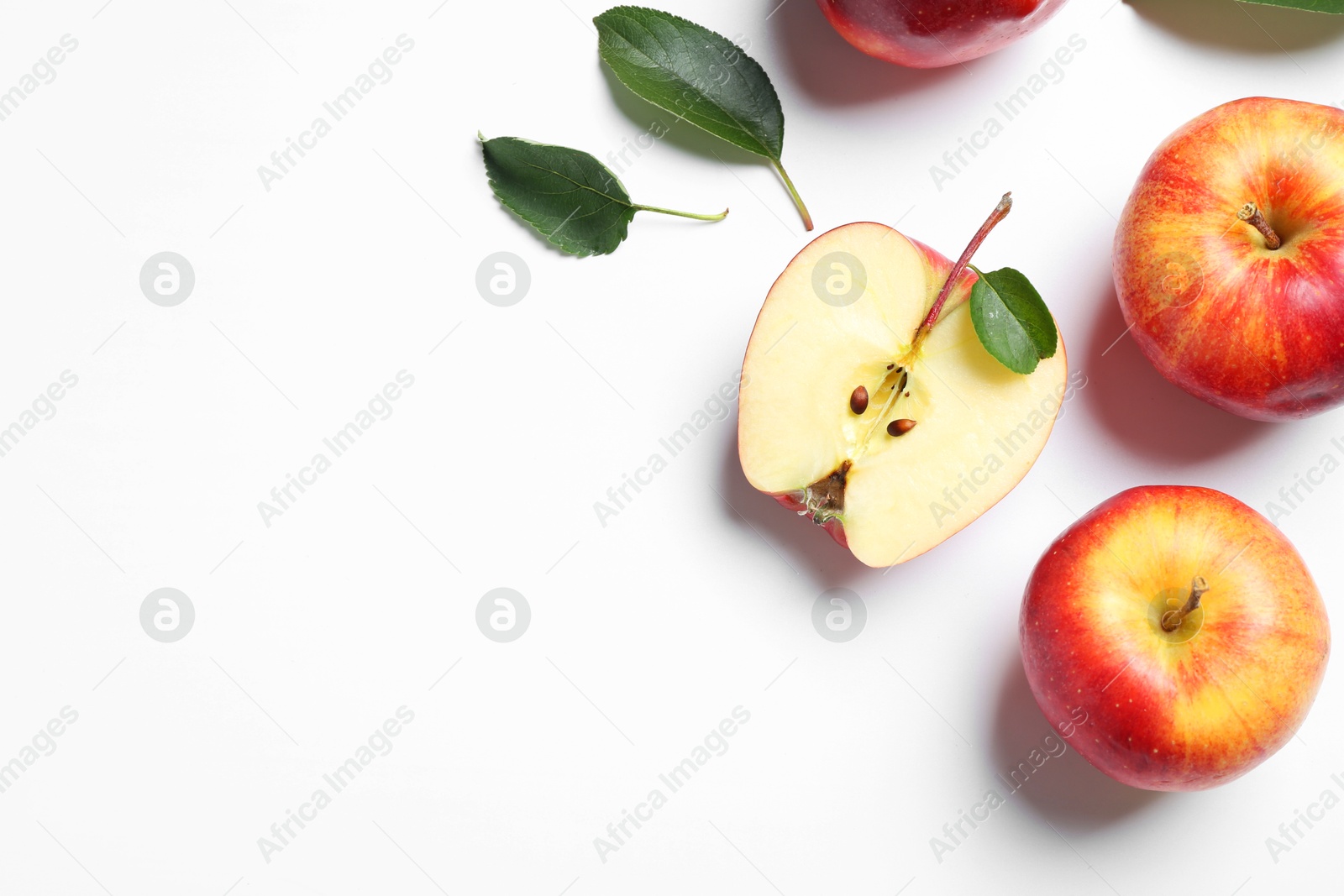 Photo of Flat lay composition with whole and cut apples on white background. Space for text