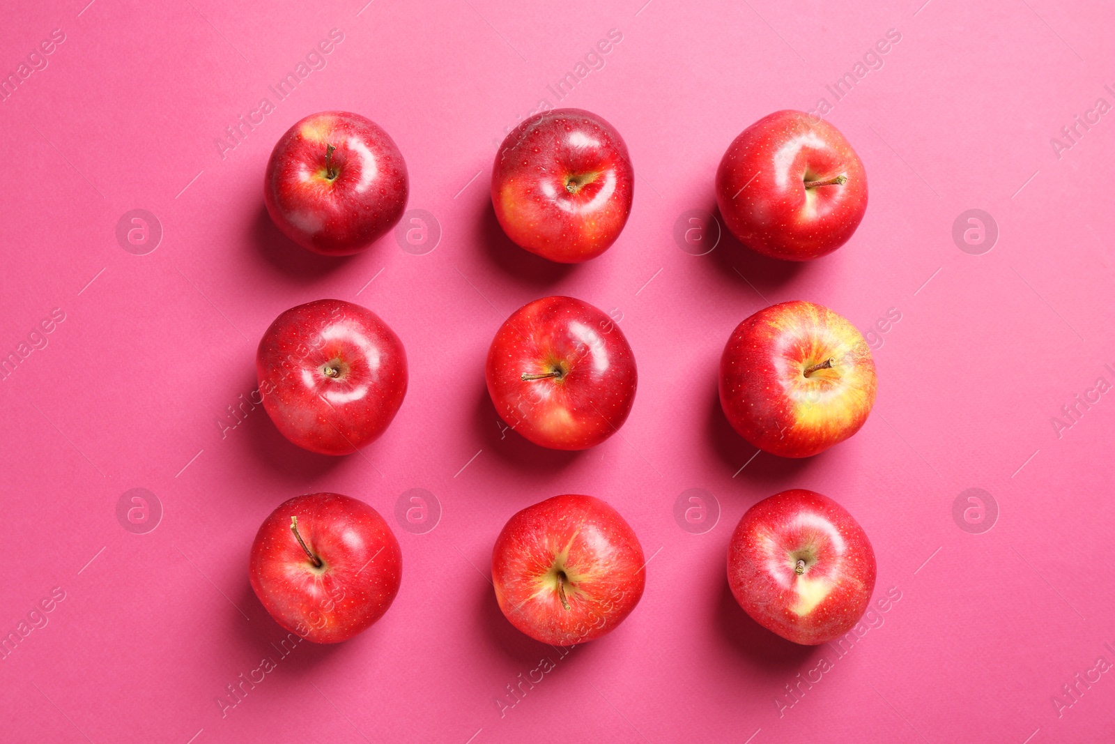 Photo of Fresh ripe red apples on pink background, flat lay