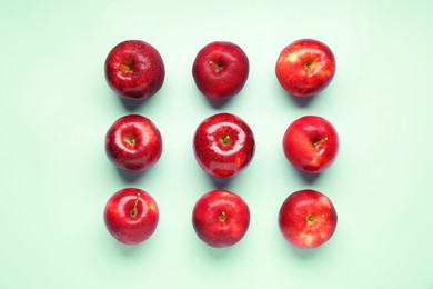 Photo of Fresh ripe red apples on light blue background, flat lay