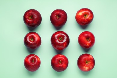 Photo of Fresh ripe red apples on light blue background, flat lay