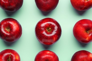 Photo of Fresh ripe red apples on light blue background, flat lay