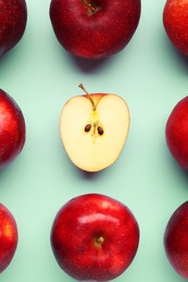 Photo of Fresh ripe red apples on light blue background, flat lay