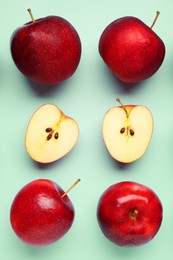 Photo of Fresh ripe red apples on light blue background, flat lay