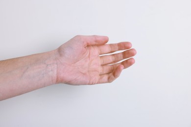 Photo of Woman with visible hand veins on white background, closeup