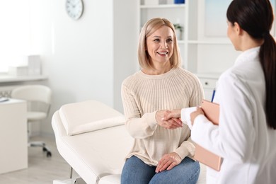 Photo of Doctor and patient shaking hands in clinic