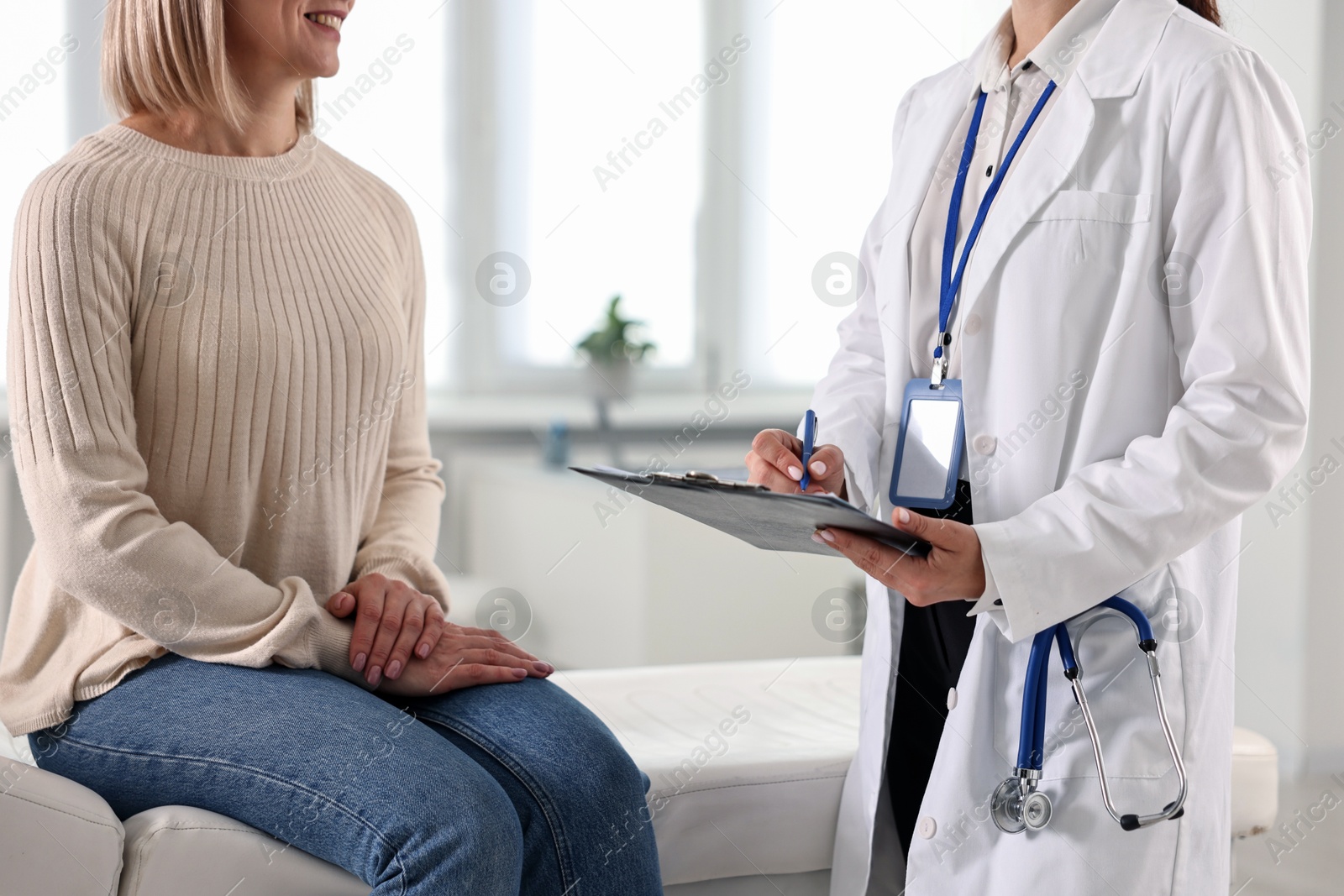 Photo of Woman having appointment with doctor in hospital, closeup