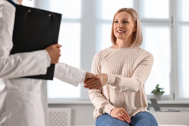 Photo of Doctor and patient shaking hands in clinic