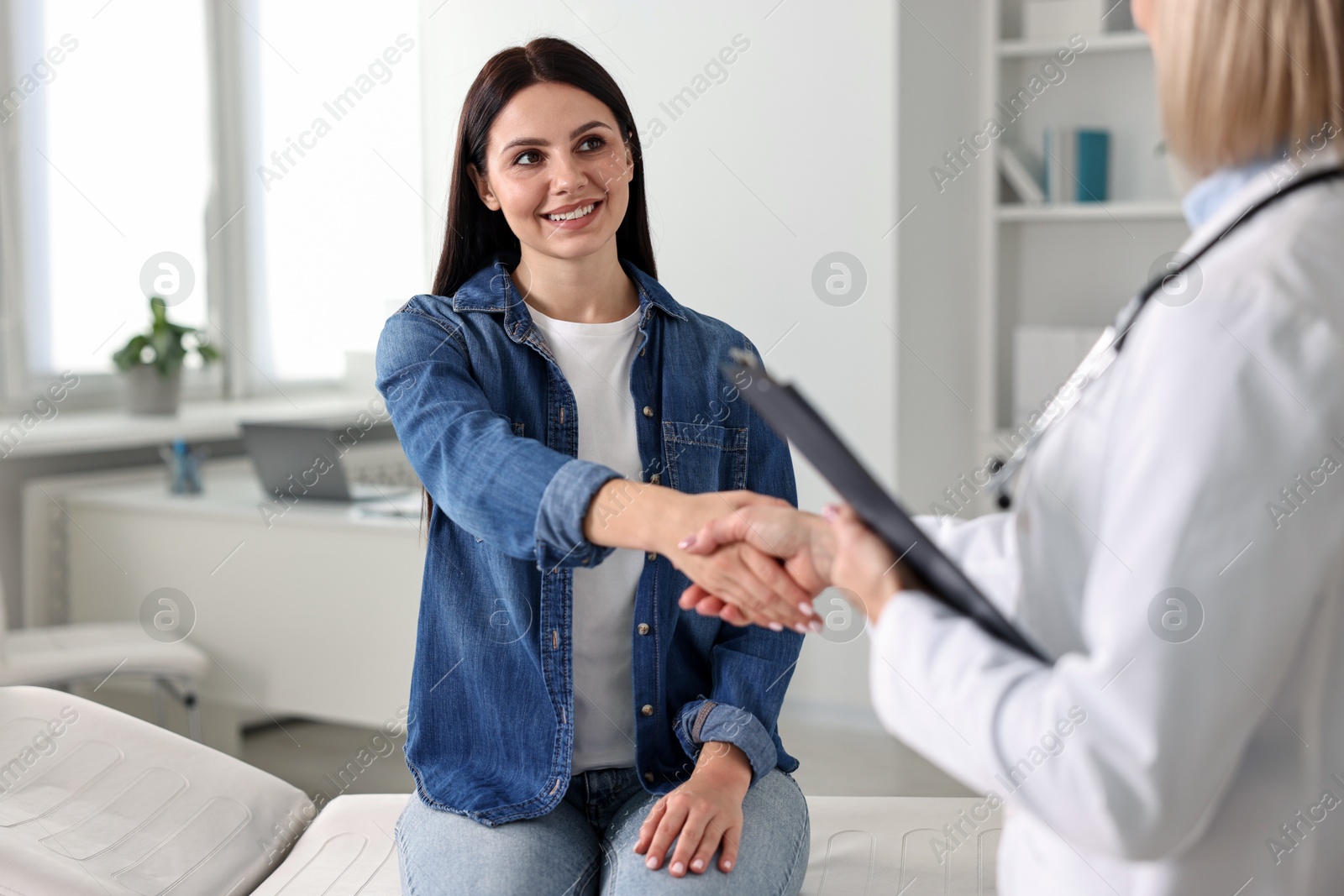 Photo of Doctor and patient shaking hands in clinic