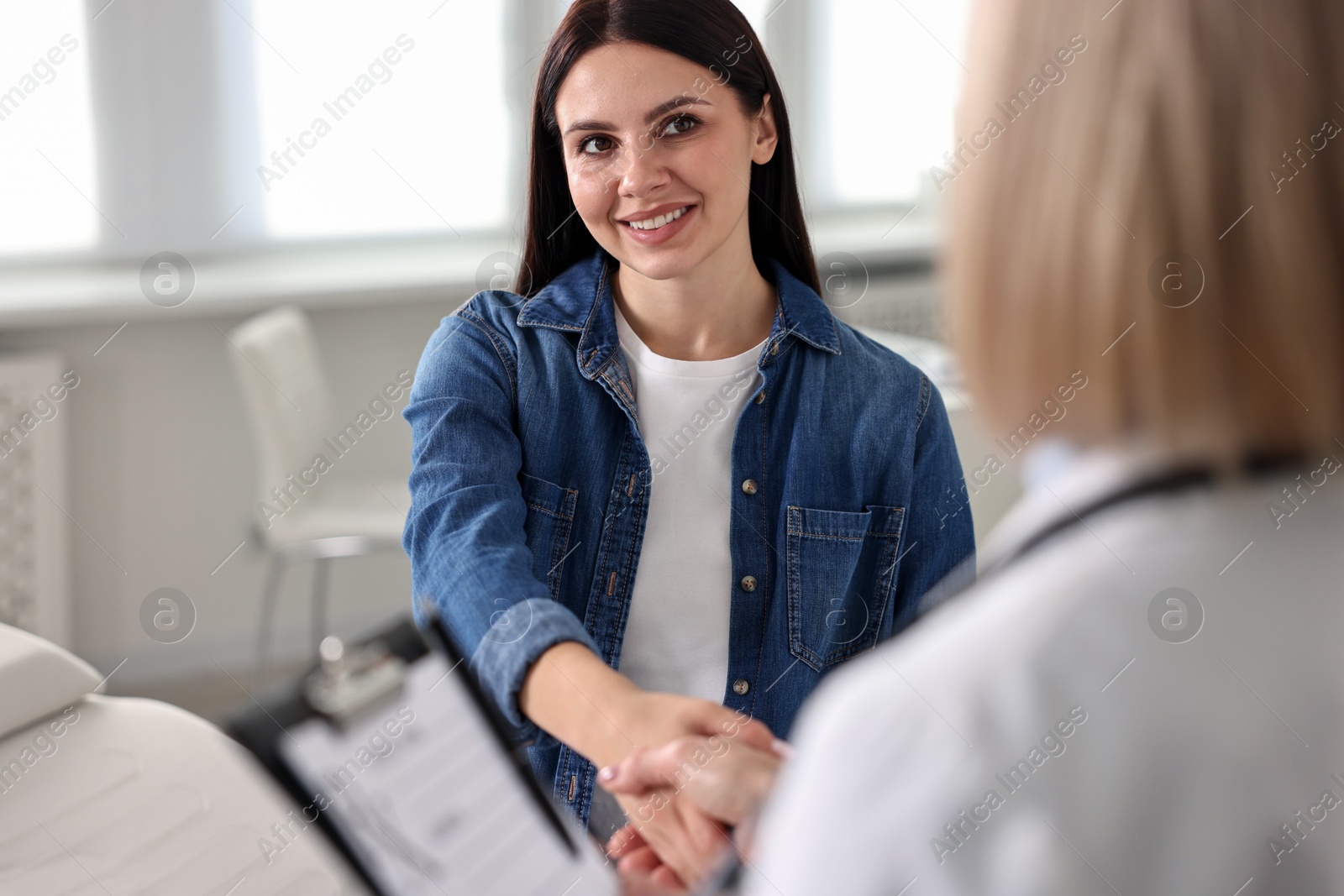 Photo of Doctor and patient shaking hands in clinic