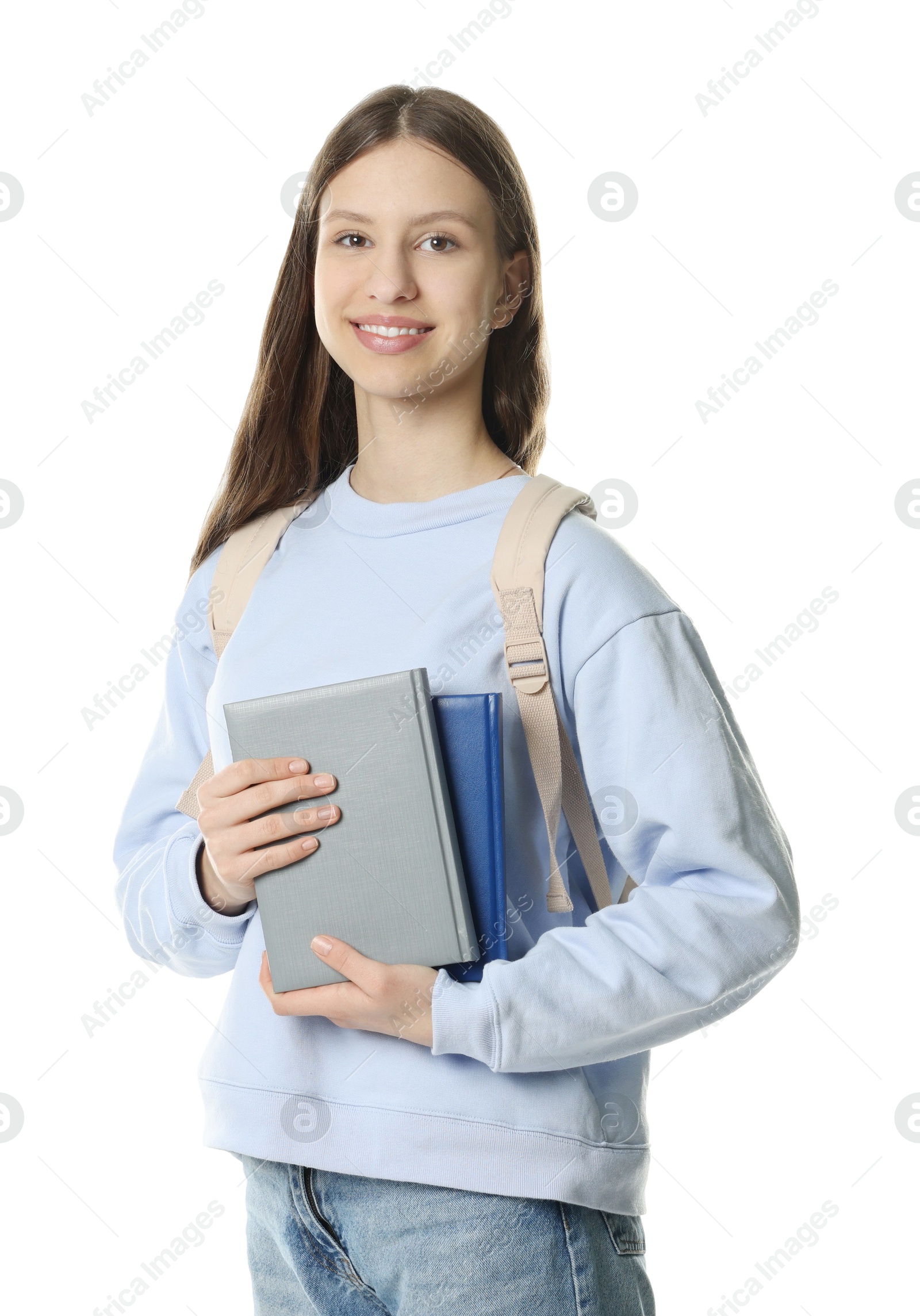 Photo of Portrait of smiling teenage girl with books on white background