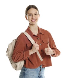 Photo of Portrait of smiling teenage girl with backpack showing thumbs up on white background