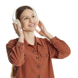 Photo of Portrait of smiling teenage girl listening to music on white background