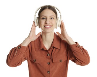 Photo of Portrait of smiling teenage girl listening to music on white background