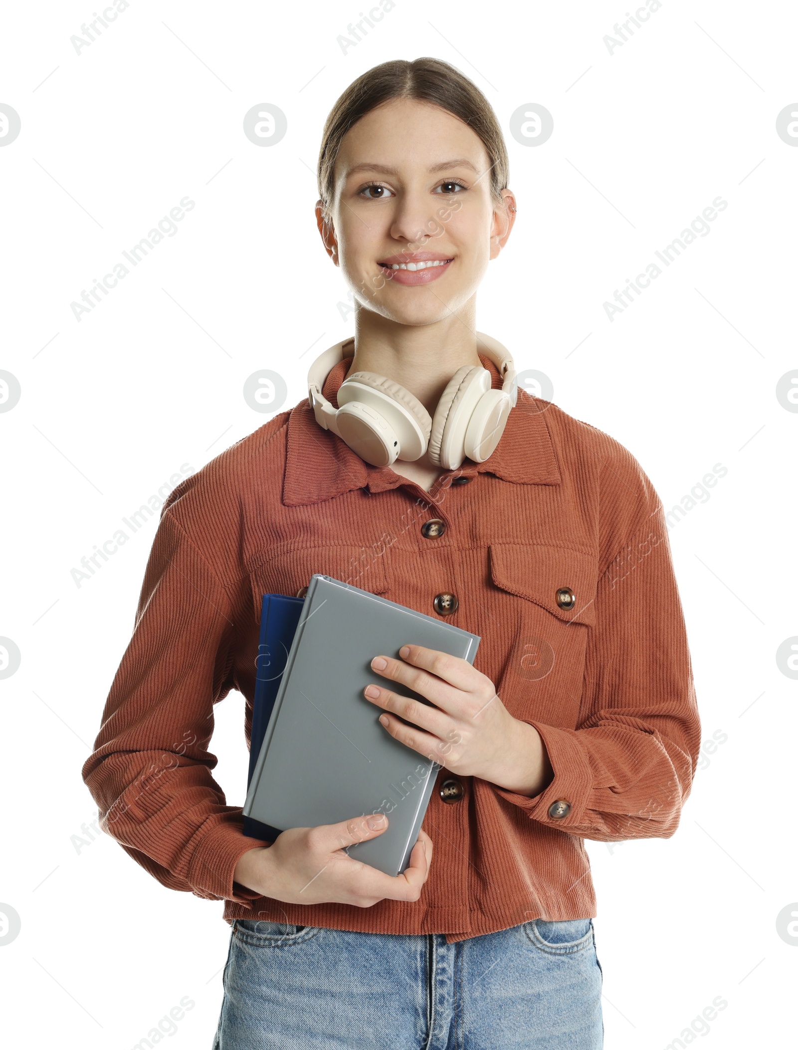 Photo of Portrait of smiling teenage girl with books and headphones on white background