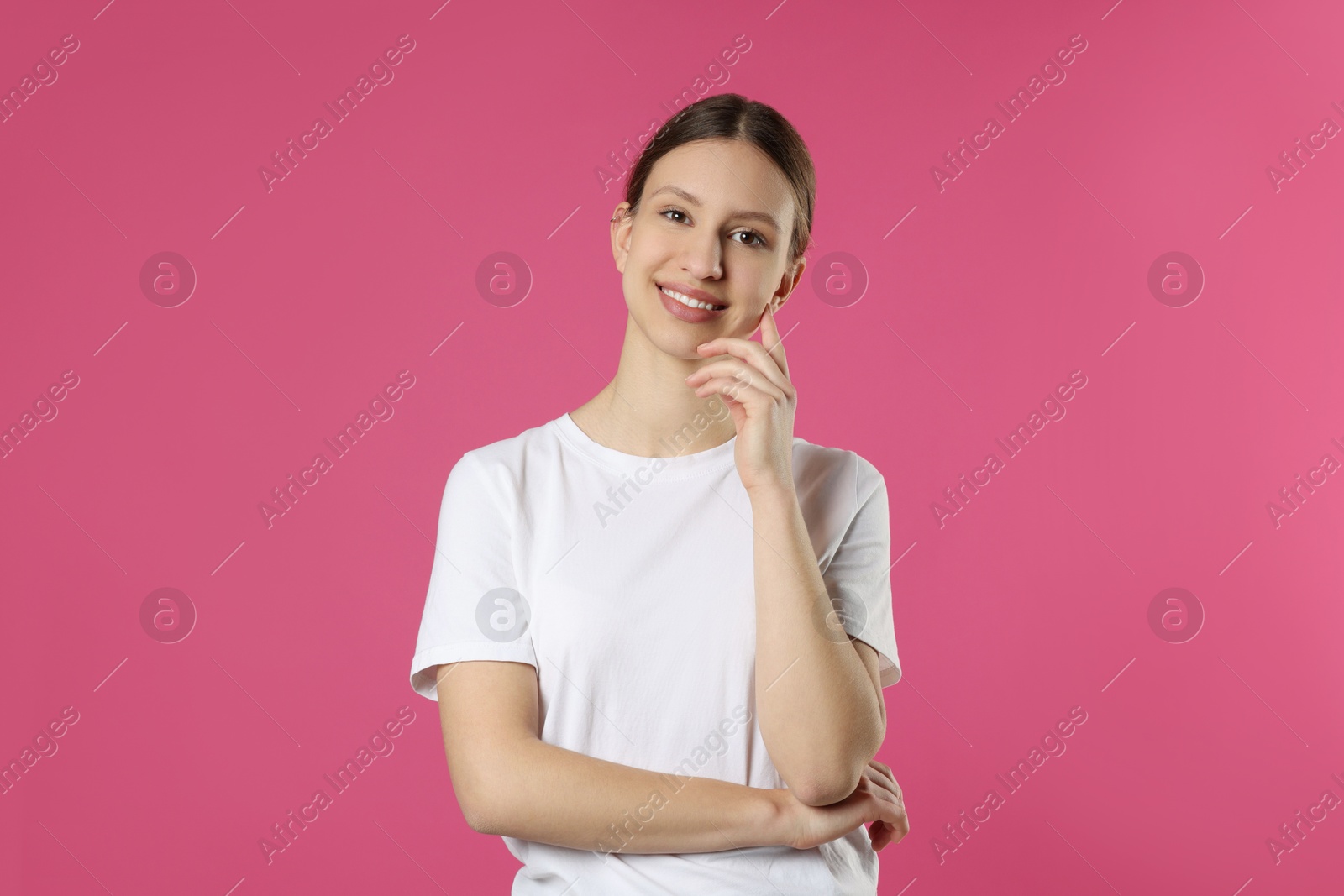 Photo of Portrait of smiling teenage girl on pink background