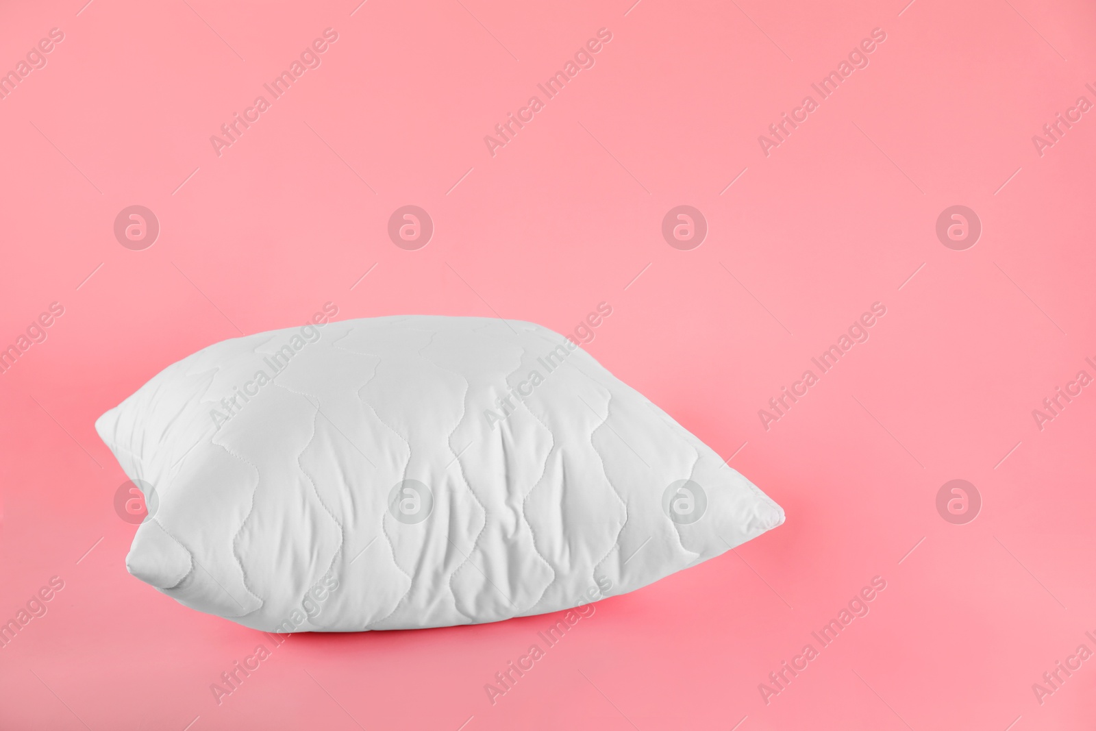 Photo of Pillow with clean pillowcase on pink background