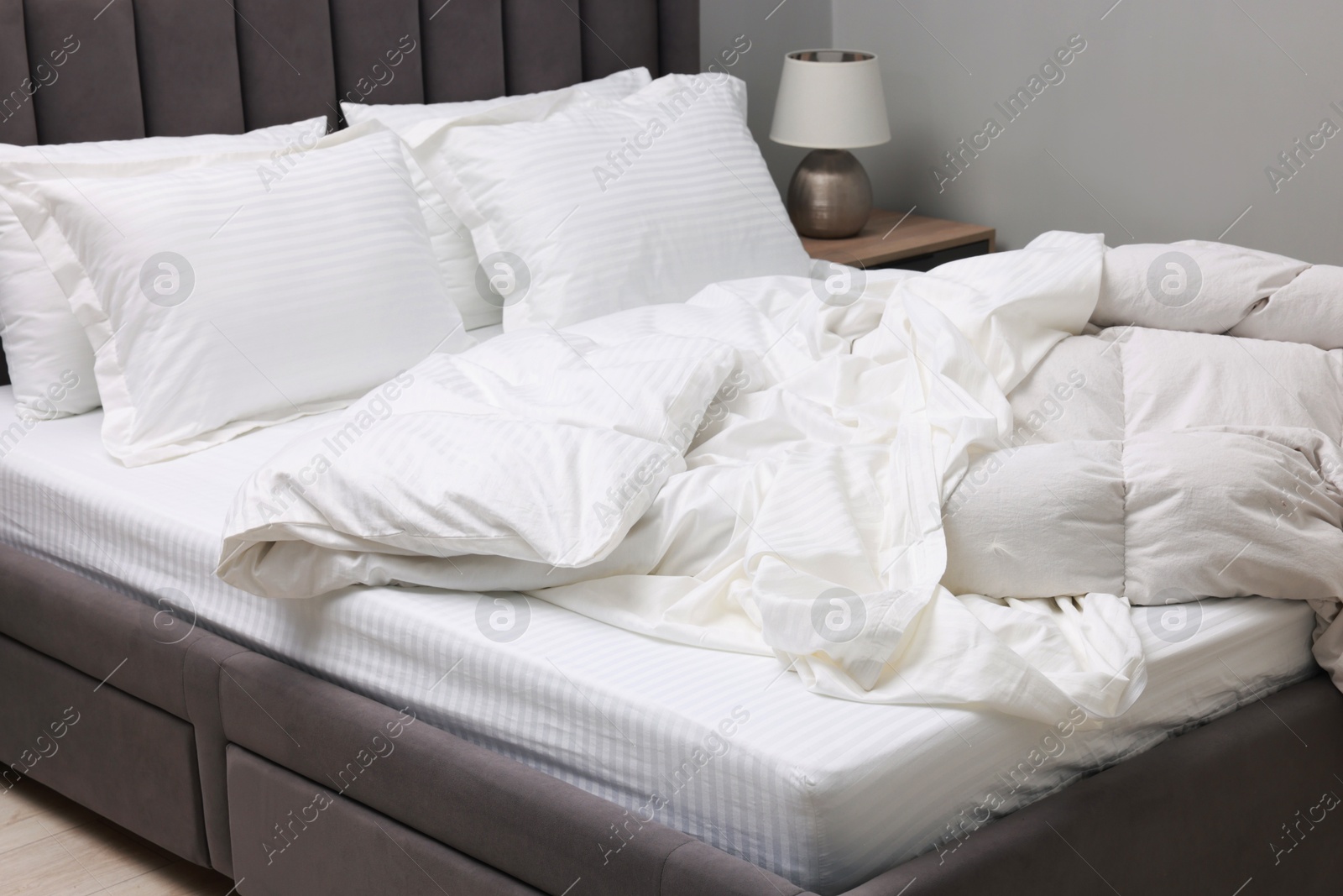 Photo of Bed with clean linens, blanket and pillows at home