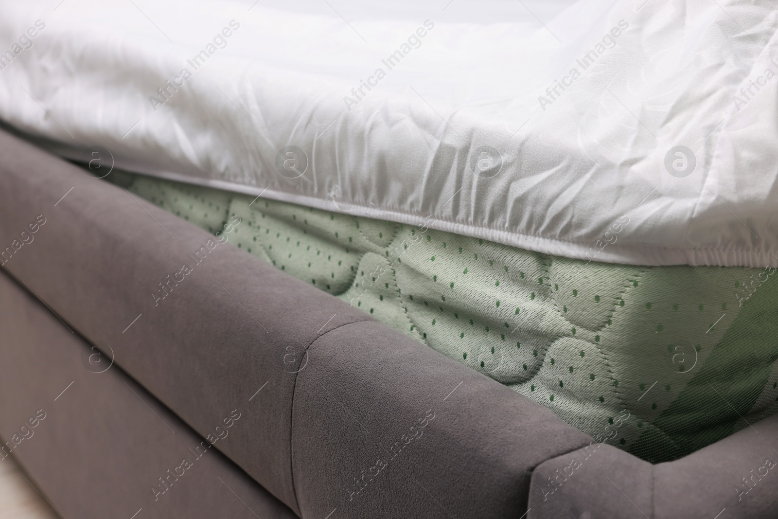 Photo of Bed with white clean linens at home, closeup