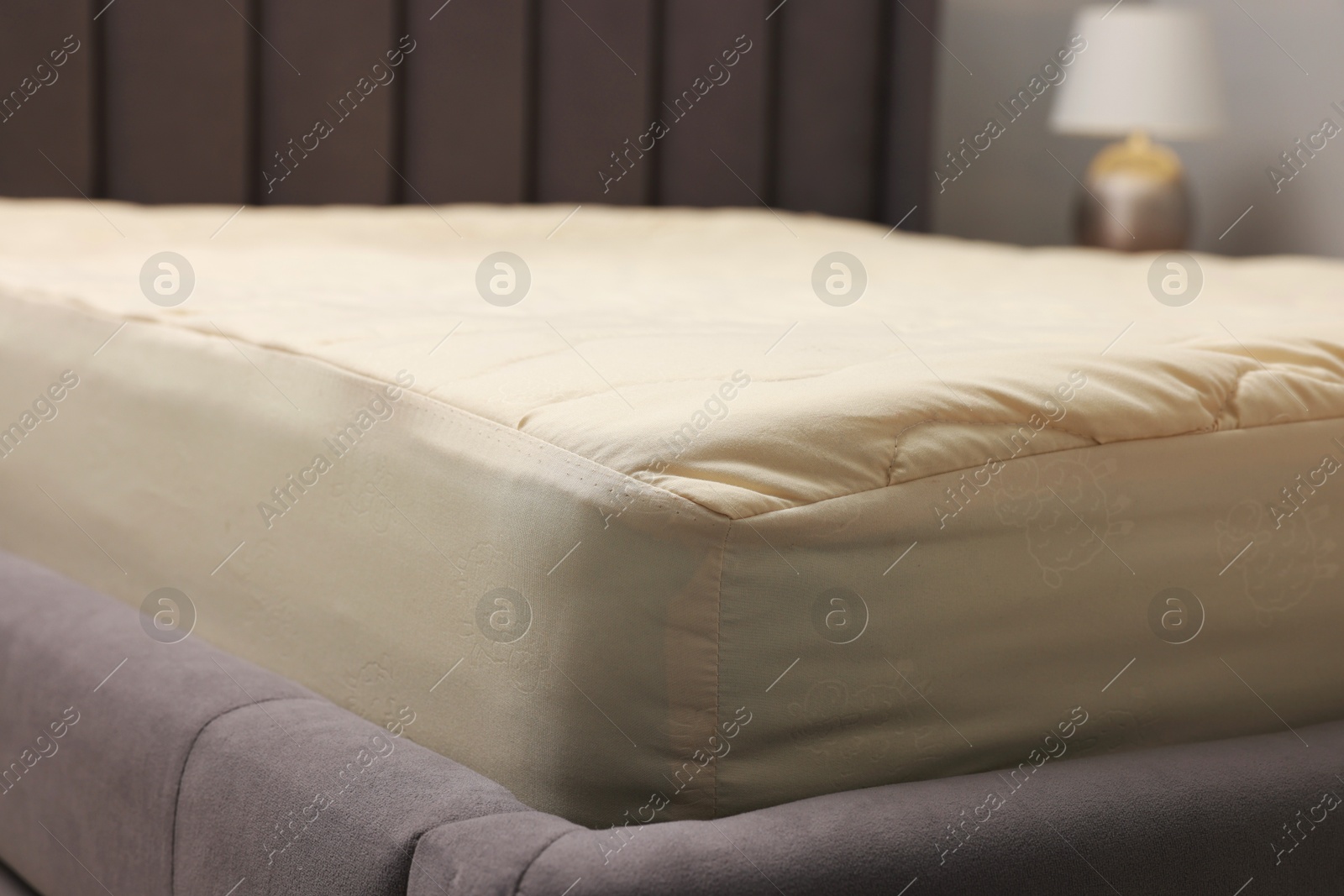 Photo of Comfortable bed with clean linens indoors, closeup view