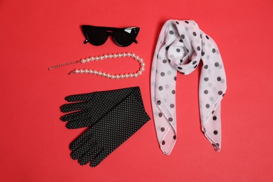 Photo of Stylish accessories on red background, flat lay