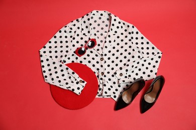 Photo of Retro styled outfit on red background, flat lay