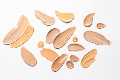 Photo of Samples of foundations on white background, top view