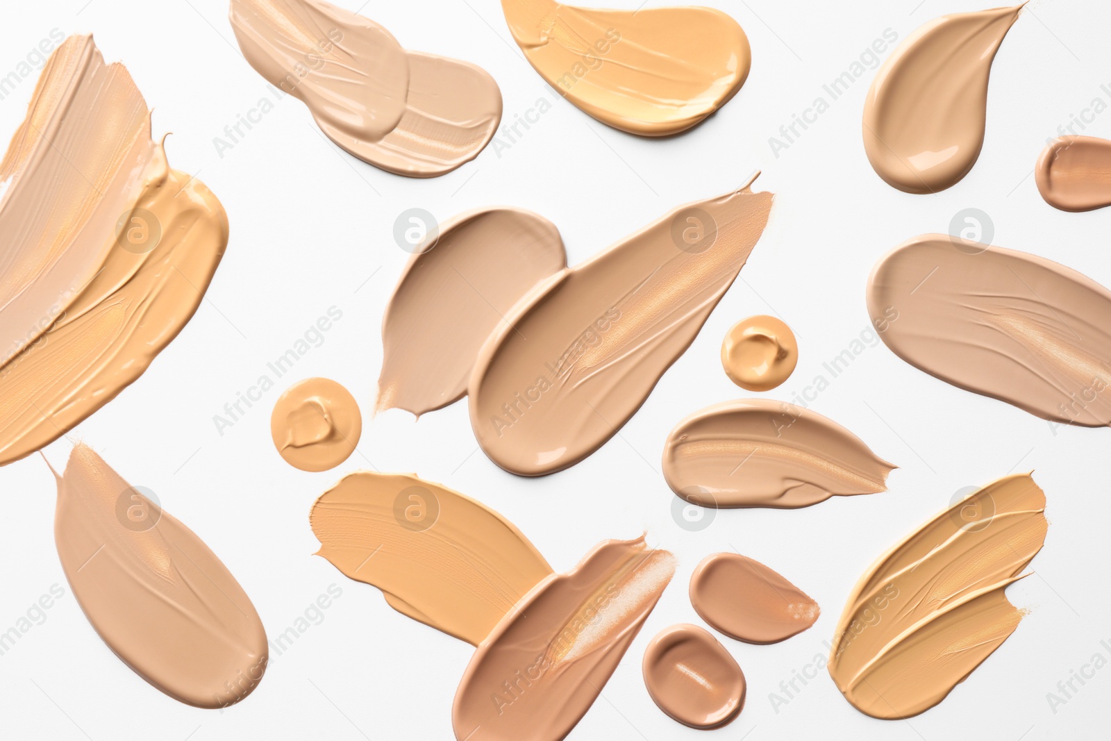 Photo of Samples of foundations on white background, top view