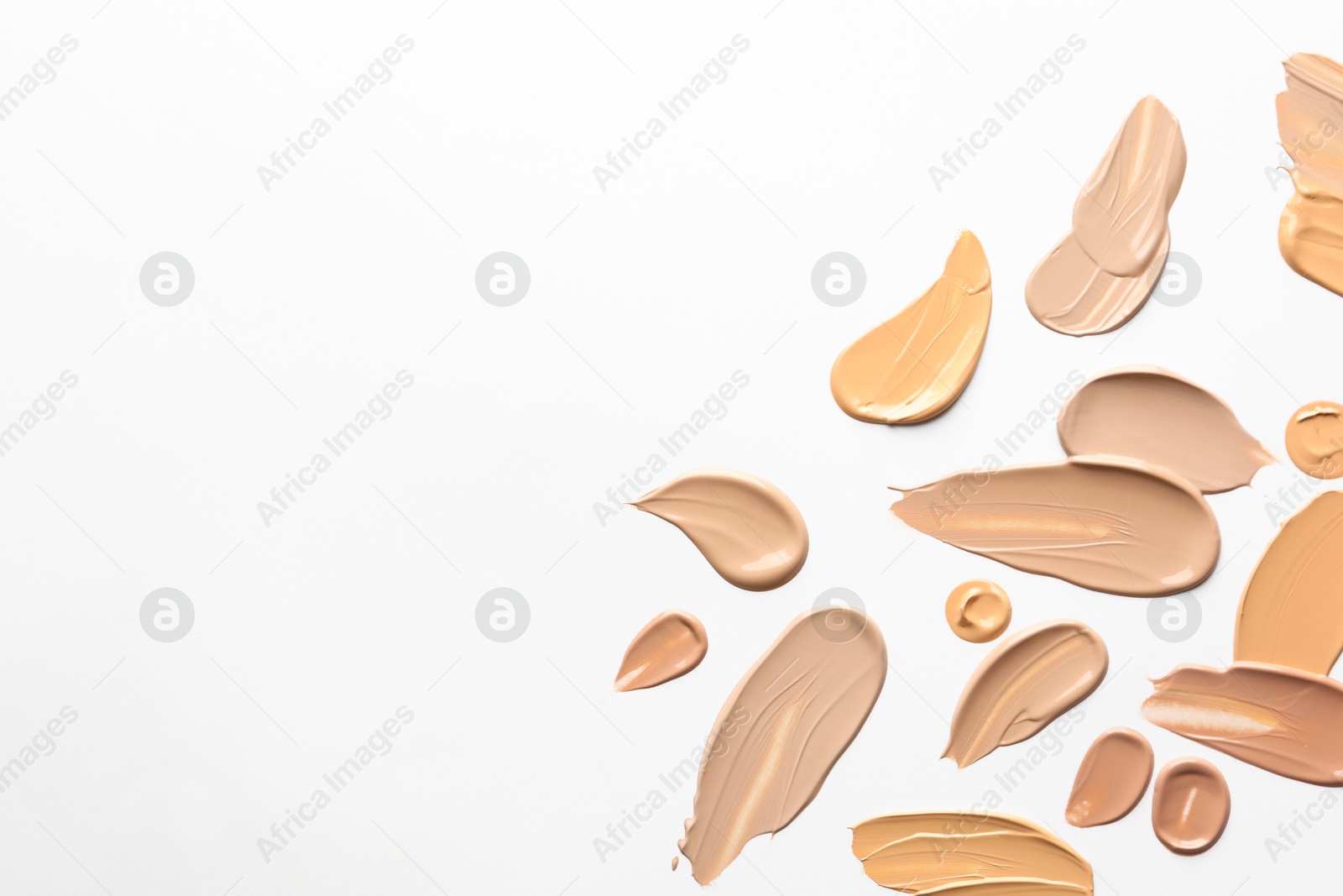 Photo of Samples of foundations on white background, top view